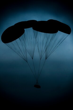 A piece of cargo descends after being dropped by a C-17 Globemaster during a 1,700 parachute Joint Operational Access Exercise Feb. 25, 2013, at Fort Bragg, N.C. More than 20 pieces of equipment were dropped during the twilight low light air drop. (U.S. Air Force photo by Senior Airman Daniel Hughes)