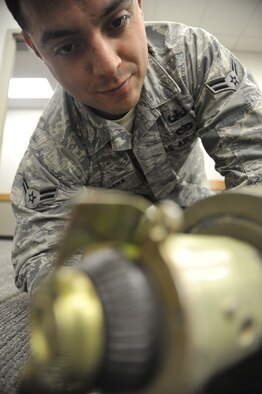 WHITEMAN AIR FORCE BASE, Mo. -- Airman 1st Class Fernando Aguilera, 509th Civil Engineer Squadron Explosive Ordnance Disposal team member, conducts a check of a bomb fuse, Feb. 27. This procedure is important because an EOD member needs to know how to approach, work on and defuse a bomb. (U.S. Air Force photo/Airman 1st Class Keenan Berry) (Released) 

