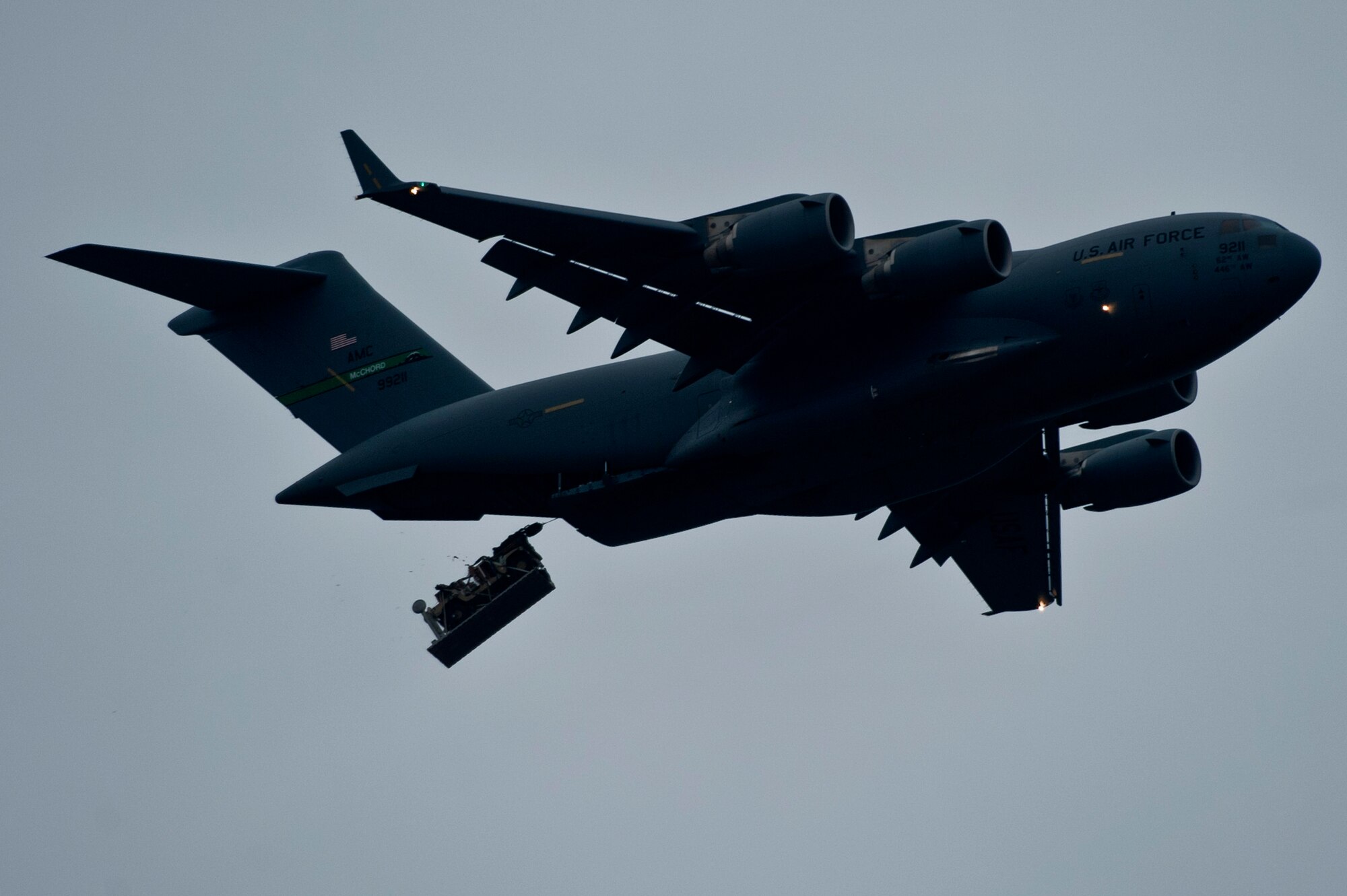 A U.S. Air Force C-17 Globemaster from Charleston Air Force Base, S.C. drops cargo during a 1,700 parachute Joint Operational Access Exercise Feb. 25, 2013, at Fort Bragg, N.C. The cargo dropped ranges from back-hoes to HMMWVs. (U.S. Air Force photo by Senior Airman Daniel Hughes)