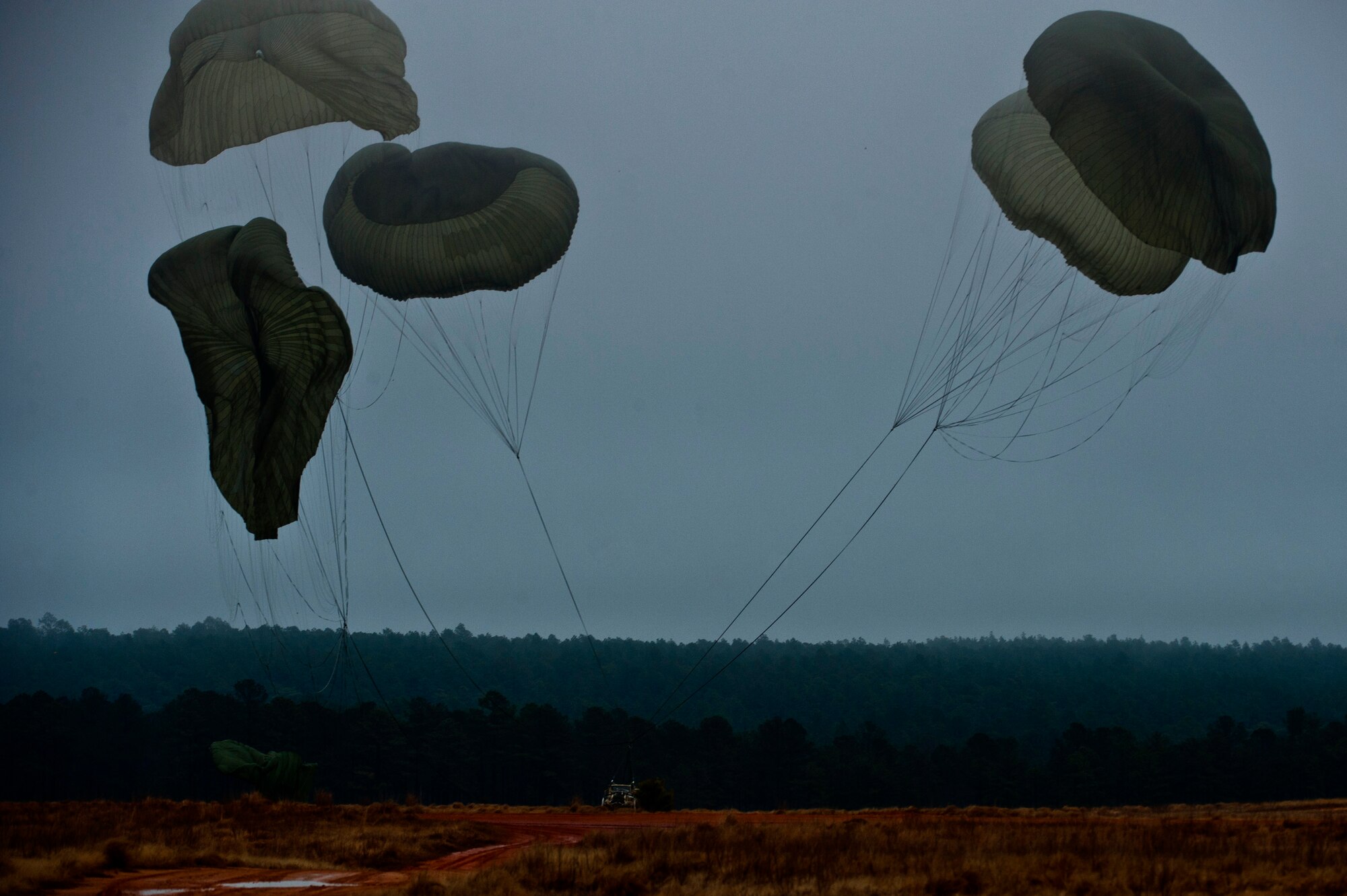A HMMWW landed during a Joint Access Operation Exercise mission Feb. 23, 2013, at Fort Bragg, N.C. Approximately 70 Airmen and Soldiers jumped from a C-17 Globemaster along with Backhoes and Rollers. (U.S. Air Force photo by Senior Airman Daniel Hughes)