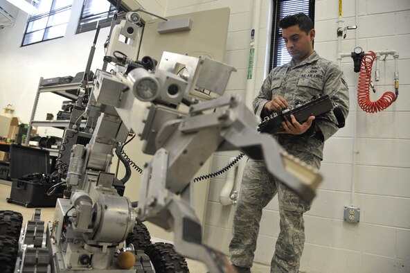 WHITEMAN AIR FORCE BASE, Mo. – Airman 1st Class Fernando Aguilera, 509th Civil Engineer Squadron Explosive Ordnance Disposal team member, operates a robot, Feb. 27. Aguilera is checking to ensure that the robot is capable of picking up an improvised explosive device. (U.S. Air Force photo/Airman 1st Class Keenan Berry) (Released) 

