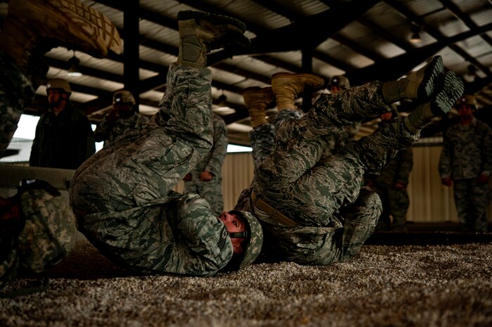 U.S. Air Force Staff Sgt. William Harman, 820th Rapid Engineer Deployable Heavy Operational Repair Squadron Engineers Airborne from Nellis Air Force Base, Nev., looks over his shoulder during practice landing rolls before participating in a Joint Access Operation Exercise jump mission Feb. 23, 2013, at Fort Bragg, N.C. JOAX gives airborne units the opportunity to stay current on qualifications and be able to perform a full-spectrum of operational skills during a parachute assault. (U.S. Air Force photo by Senior Airman Daniel Hughes)