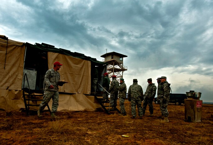 U.S. Air Force Airmen from the 820th Rapid Engineer Deployable Heavy Operational Repair Squadron Engineers Airborne, Nellis Air Force Base, Nev., get morning chow on Holland Air Field during Joint Access Operation Exercise 2013 Feb. 22, at Fort Bragg, N.C. RED HORSE Airborne Airmen work 12- hour shifts during the exercise, weather permitting. (U.S. Air Force photo by Senior Airman Daniel Hughes)