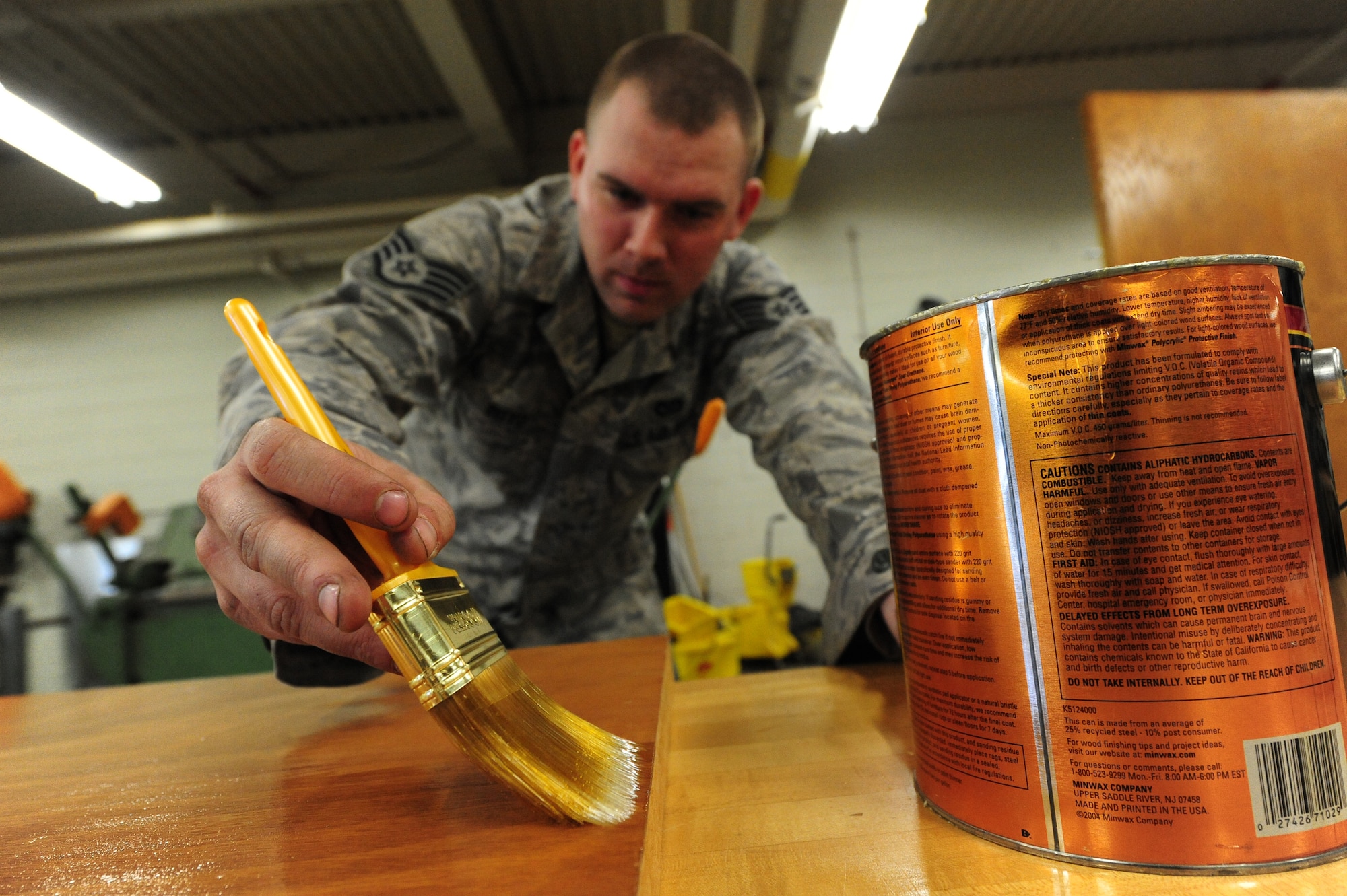 WHITEMAN AIR FORCE BASE, Mo. -- Staff Sgt. Adam Boyd, 509th Civil Engineer Squadron structural supervisor, polishes a wooden door with polyurethane, Feb. 27. The polish provides a durable protective finish that guards against the absorption of moisture. (U.S. Air Force photo/Staff Sgt. Nick Wilson) (Released)