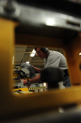 WHITEMAN AIR FORCE BASE, Mo. -- Albert Cote, 509th Civil Engineer Squadron carpenter, cuts a piece of wood for a door frame with a compound miter saw, Feb. 27. Cote works with a team of professionals responsible for performing all aspects of carpentry and masonry, including sheet metal, wood and welding work. (U.S. Air Force photo/Staff Sgt. Nick Wilson) (Released)