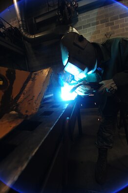 WHITEMAN AIR FORCE BASE, Mo. -- Senior Airman Michael Rafael, 509th Civil Engineer Squadron structural journeyman, welds a box blade for a snow plow, Feb. 27. Structural journeymen are responsible for maintaining knowledge and proficiency in metal layout, metal fabrication, welding, cutting, brazing and lock-smithing. (U.S. Air Force photo/Staff Sgt. Nick Wilson) (Released)