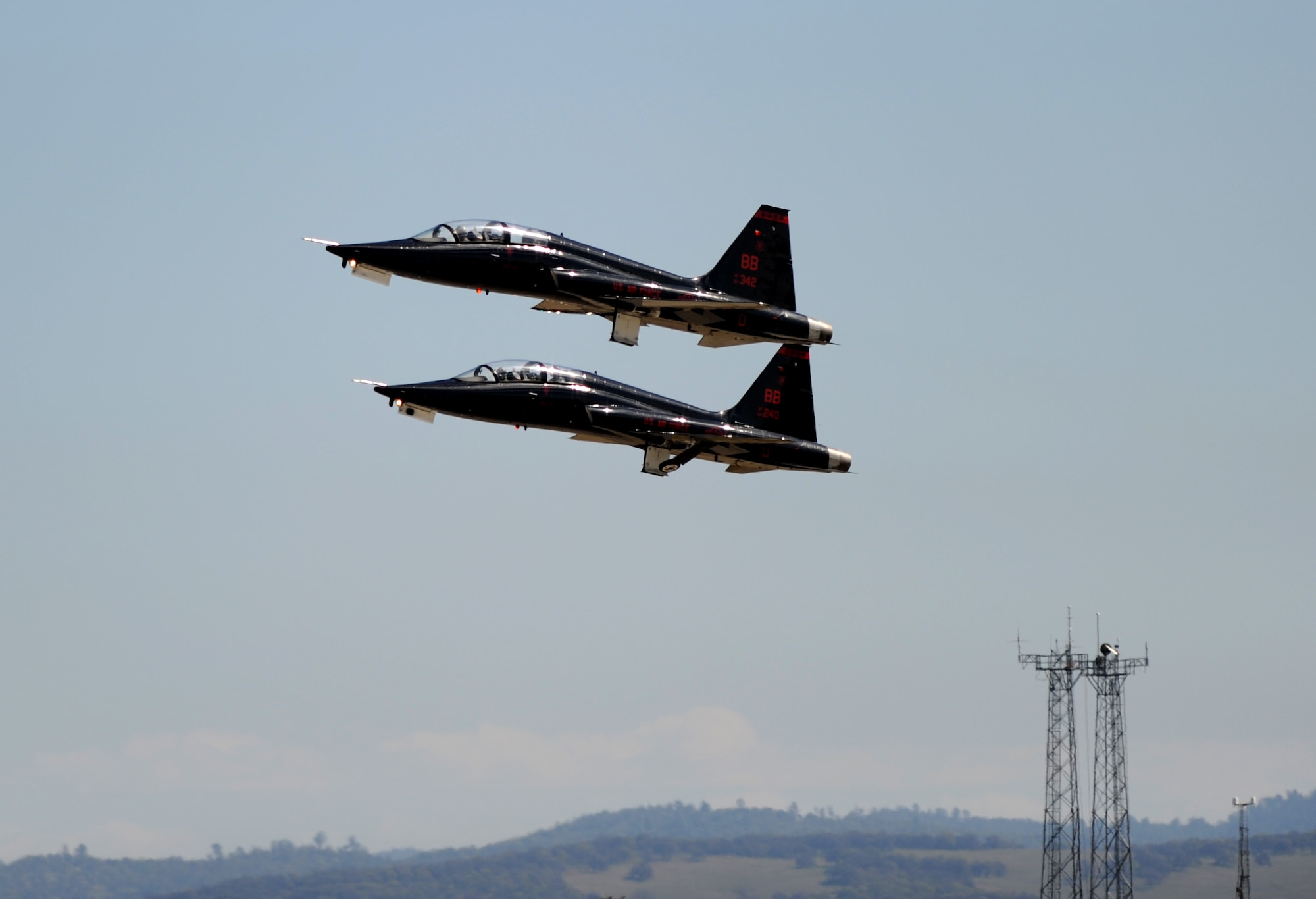 Two T-38 Talon jet trainer aircraft raise their landing gear during a take off at Beale Air Force Base, Calif. Feb. 28, 2013. Beale’s Talons are painted black to mirror the U-2 “Dragon Lady.” (U.S. Air Force photo by Staff Sgt. Robert M. Trujillo/Released)