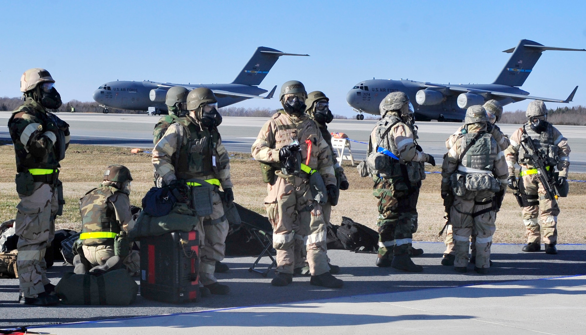 Airmen with the 436th and 512th Airlift Wings wait to be transported to their play area following a simulated attack Mar. 4, 2013, at Dover Air Force Base, Del. The Airmen participated in an Operational Readiness Exercise, which ran from Mar. 2 through Mar. 8. (U.S. Air Force photo/Tech. Sgt. Chuck Walker)