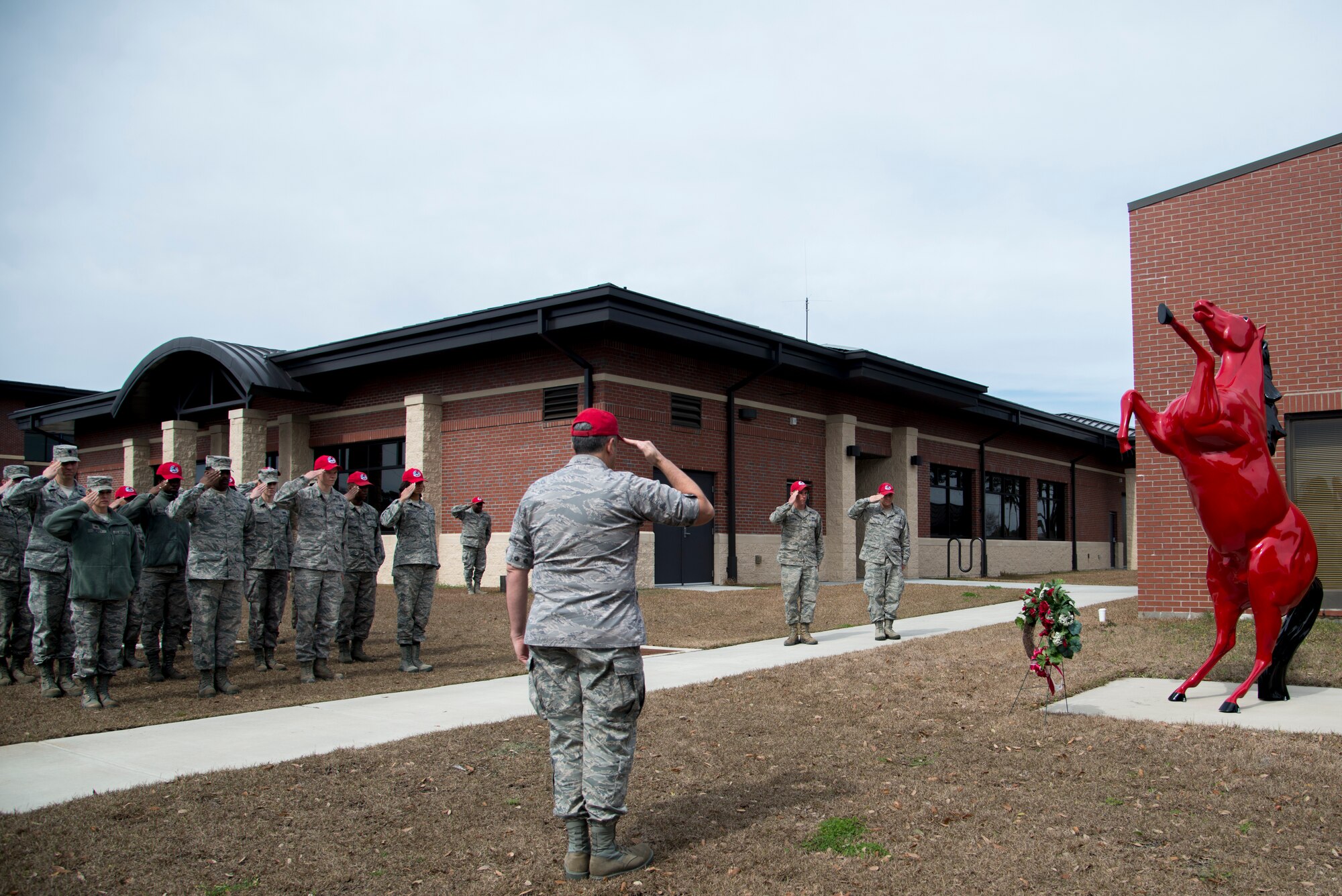 Lt. Col. Joseph Swaim, 560th Rapid Engineer Deployable, Heavy Operational Repair Squadron commander, along with other Joint Base Charleston – Air Base Airmen salute as Taps plays during a memorial ceremony in honor of Brig. Gen. Tom Meredith Feb. 27, 2013, at JB Charleston, S.C. Meredith founded the RED HORSE unit, and was the first commander of the active-duty RED HORSE unit when it was established to train RED HORSE Airmen for service in Vietnam in 1967.