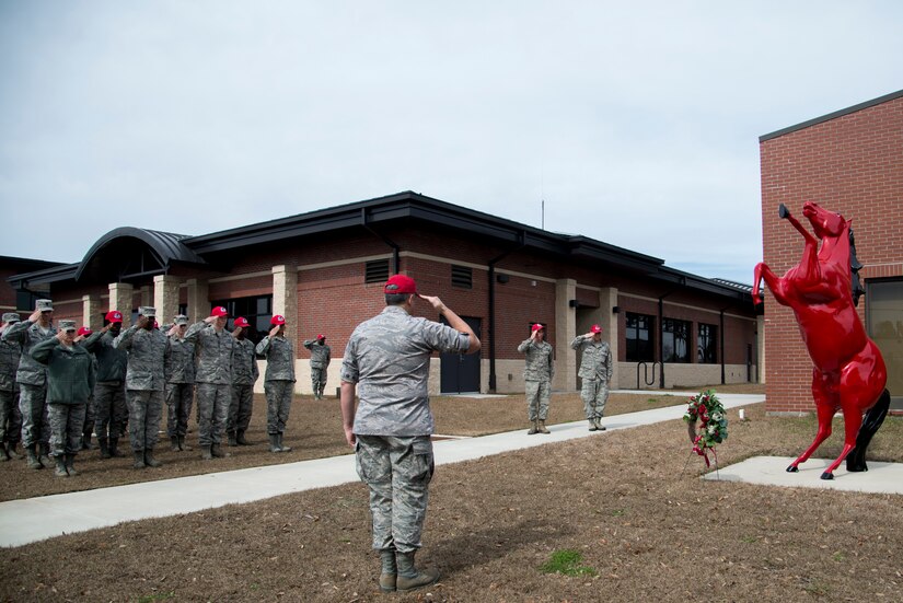 Lt. Col. Joseph Swaim, 560th Rapid Engineer Deployable, Heavy Operational Repair Squadron commander, along with other Joint Base Charleston – Air Base Airmen salute as Taps plays during a memorial ceremony in honor of Brig. Gen. Tom Meredith Feb. 27, 2013, at JB Charleston, S.C. Meredith founded the RED HORSE unit, and was the first commander of the active-duty RED HORSE unit when it was established to train RED HORSE Airmen for service in Vietnam in 1967.