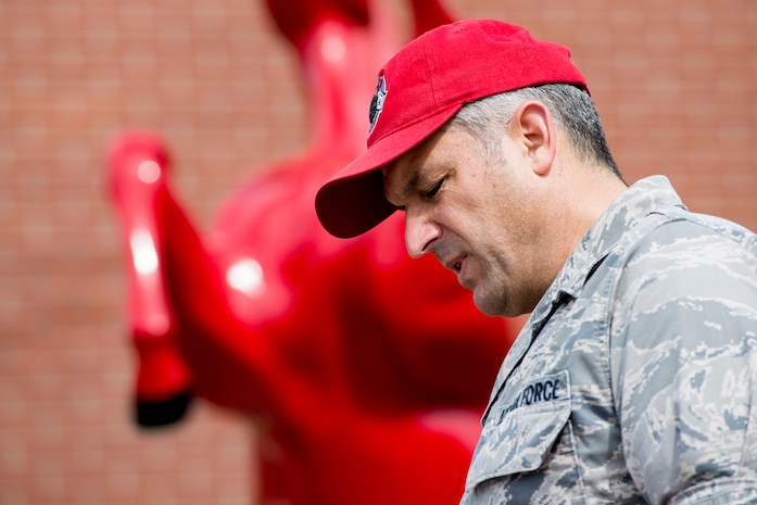 Lieutenant Colonel Joseph Swaim, 560th Rapid Engineer Deployable, Heavy Operational Repair Squadron commander, honors Brig. Gen. Tom Meredith, during a memorial ceremony Feb. 27, 2013, at Joint Base Charleston – Air Base, S.C. Meredith founded the RED HORSE unit, and was the first commander of the active-duty RED HORSE unit when it was established to train RED HORSE Airmen for service in Vietnam in 1967.