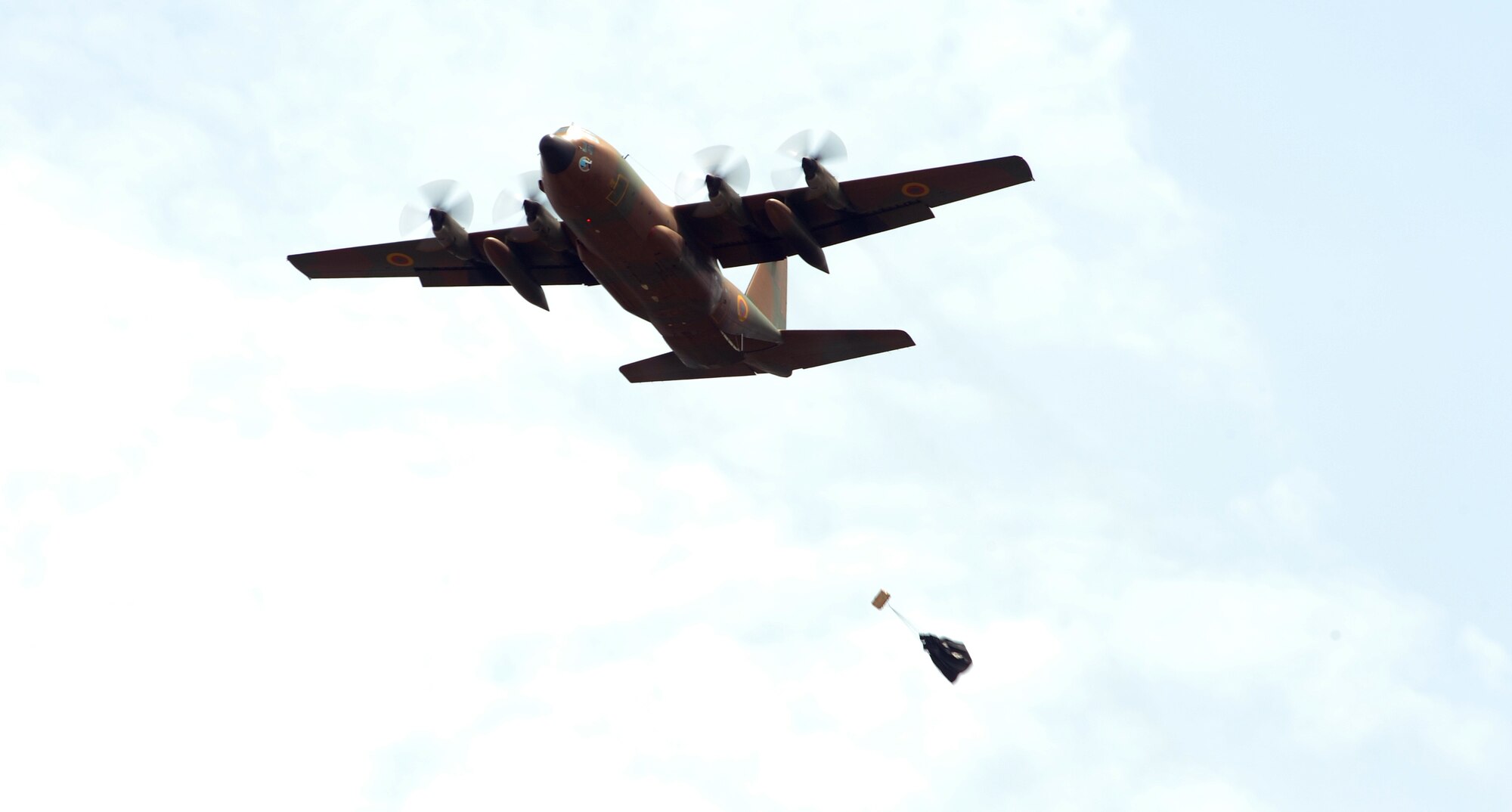 DOUALA, CAMEROON – A Cameroon Air Force C-130 drops a low-cost low-altitude bundle following placement of an aerial delivery drop zone marker by U.S. Army 560th Battlefield Surveillance Brigade personnel and Cameroon Defense Forces members during Central Accord 2013, at the Cameroon Defense Forces Engineer Base, Douala, Cameroon, February 27, 2013. The Atlanta, GA, based U.S. Army pathfinder members are participating in Central Accord 2013, a joint exercise in which U.S., Cameroon and neighboring Central African militaries partner to promote regional cooperation while and increasing aerial resupply and medical readiness capacity. (Photo by Master Sgt. MSgt Stan Parker, 621st CRW Public Affairs)