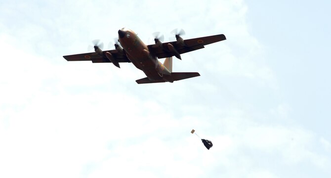 A Cameroon air force C-130 drops a low-cost low-altitude bundle following placement of an aerial delivery drop zone marker by U.S. Army 560th Battlefield Surveillance Brigade personnel and Cameroon defense Forces members during Central Accord 2013, at the Cameroon defense forces engineer base, Douala, Cameroon, February 27, 2013. The Atlanta, Ga.-based U.S. Army pathfinder members are participating in Central Accord 2013, a joint exercise in which U.S., Cameroon and neighboring Central African militaries partner to promote regional cooperation while and increasing aerial resupply and medical readiness capacity. (Photo by Master Sgt. MSgt Stan Parker)