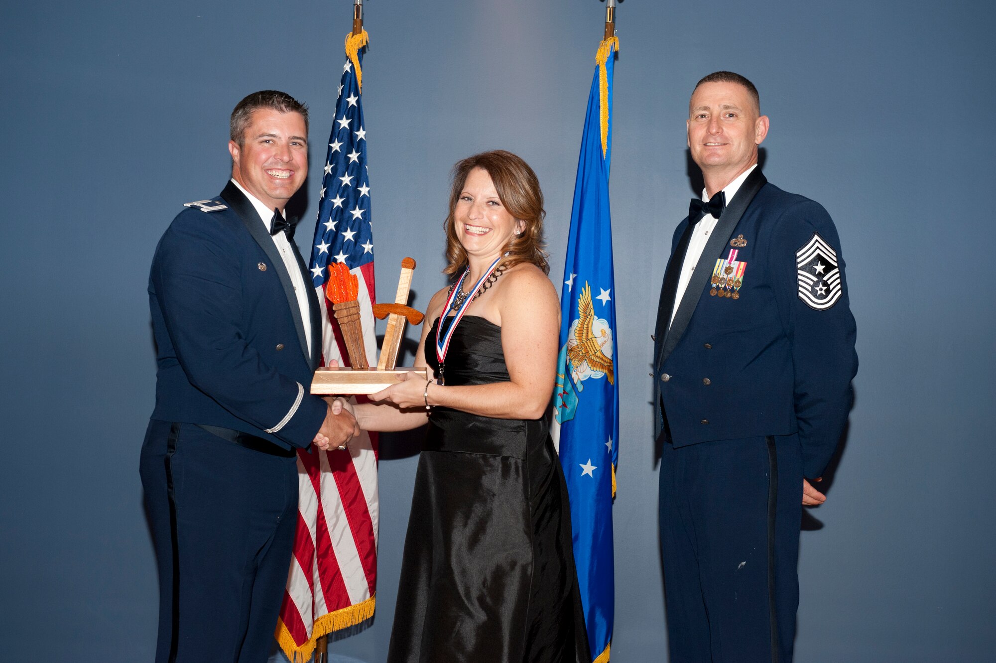 Mrs. Stacey York, spouse of Lt. Col. Robert York, earns the 2012 Team Tyndall Annual Spouse of the Year Award during a ceremony at the Annual Awards banquet Feb. 20 from Col. David E. Graff, 325th Fighter Wing commander, and Chief Master Sgt. Ray DeVite, 325th FW command chief. (U.S. Air Force photo by Lisa Norman)