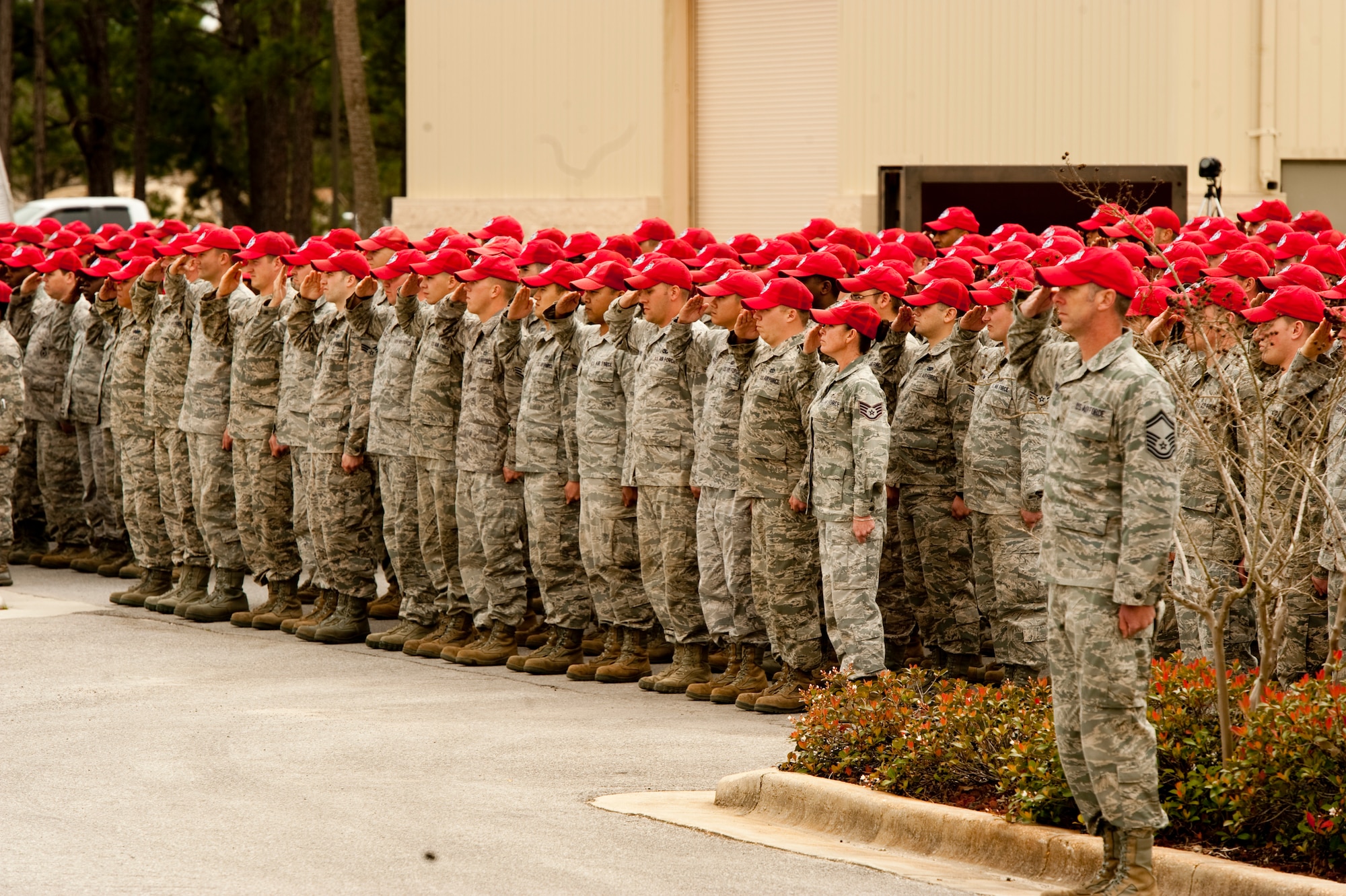 Airmen of the 823rd RED HORSE Squadron salute as the squadron flag is lowered to half-staff at Hurlburt Field, Fla., March 1, 2013.  The whole squadron participated in a tribute to retired Brig. Gen. William Thomas Meredith who passed away last month.  (U.S. Air Force Photo by Airman 1st Class Benjamin D. Kim)