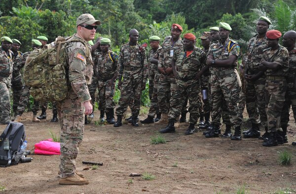 U.S. Army Staff Sgt. Nick Pence, a pathfinder member assigned to the 560th Battlefield Surveillance Brigade, Atlanta, Ga., assists a Cameroon defense forces members with setting up an aerial delivery drop zone marker prior to a Cameroon air force C-130 low-cost low-altitude bundle air drop during Central Accord 2013, at the Cameroon defense forces engineer base, Douala, Cameroon, February 27, 2013. Pence is participating in Central Accord 2013, a joint exercise in which U.S., Cameroon and neighboring Central African militaries partner to promote regional cooperation while and increasing aerial resupply and medical readiness capacity. (Photo by Master Sgt. MSgt Stan Parker)
