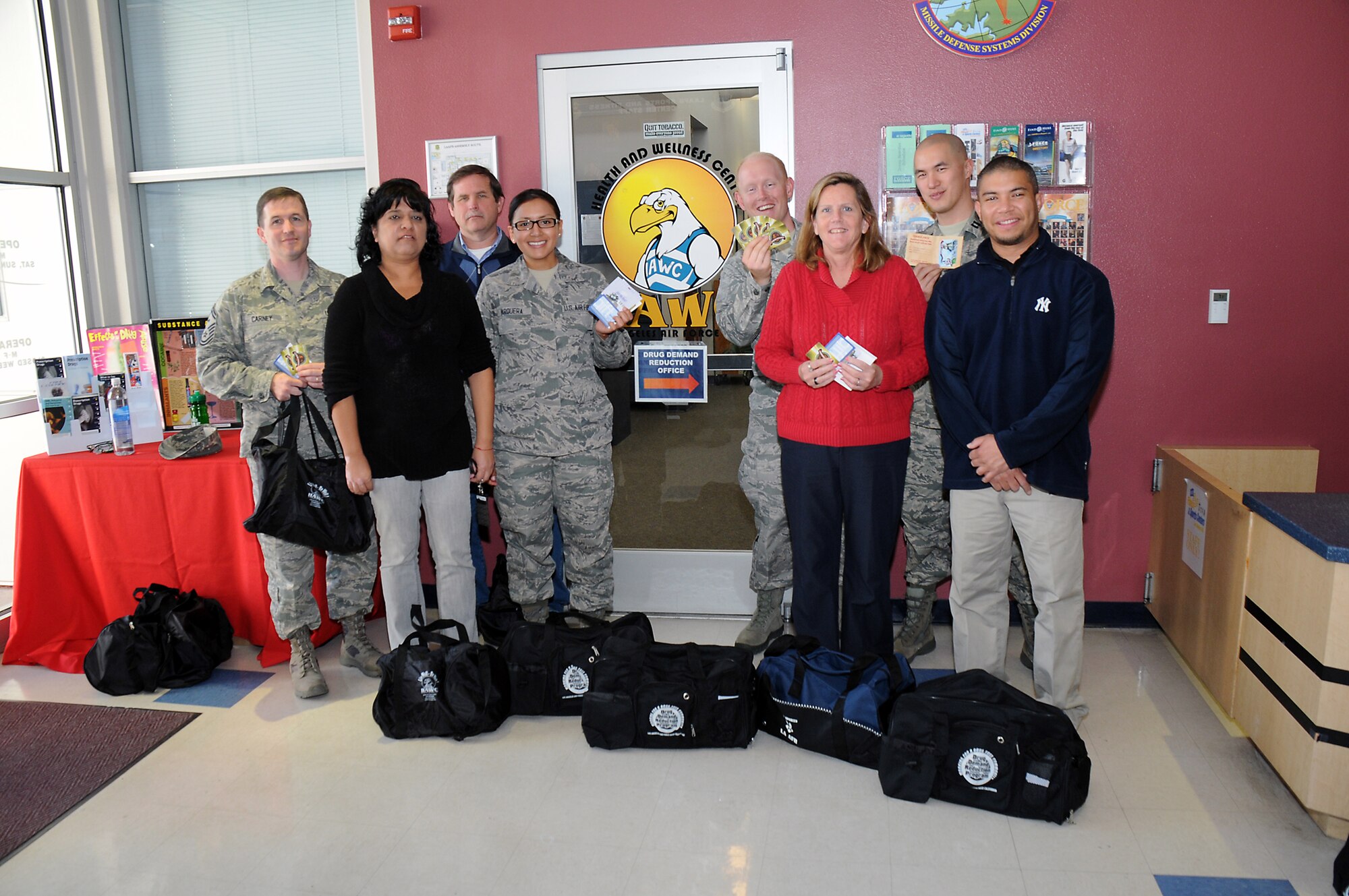 Individual and team biggest loser challenge winners who lost a total of approximately 100 pounds are announced at the Health and Wellness Center, Feb. 28.  Pictured from left to right are: Senior Master Sgt. Jeremy Carney, Graciela Rodriguez, John Jones, Airman First Class Jourdan Varquera, Lt. Jeffrey Campeau, Lisa Blackford, Capt. Albert Tao and Eugene McClelland. The annual competition encourages healthy weight loss and awards prizes to the biggest losers. (Photo by Joe Juarez)