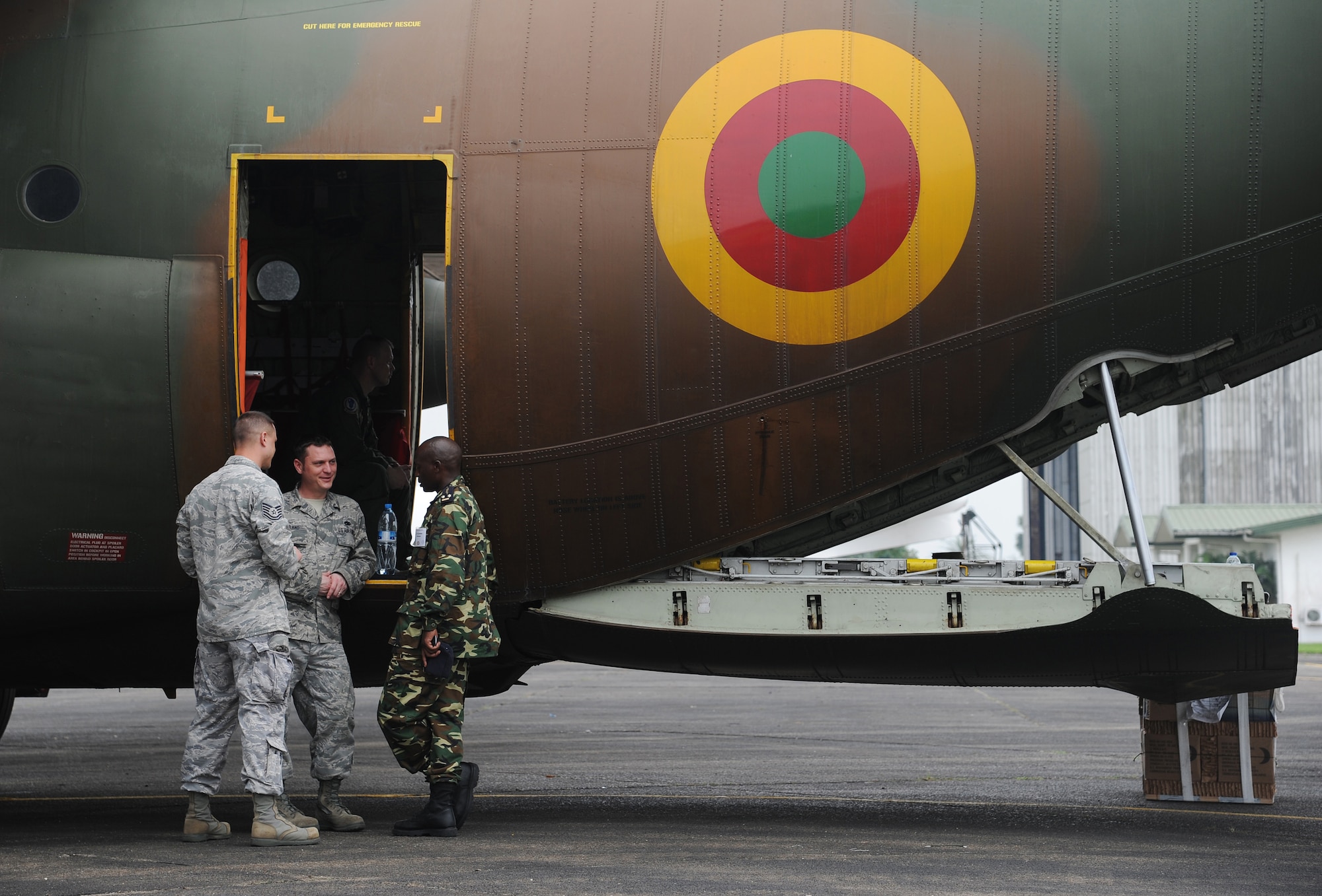 DOUALA, CAMEROON – U.S. Air Force Staff Sgt. Daniel Borowski, an aerial port air advisor and Technical Sgt. Colin Ireland, an aircraft maintenance air advisor (l to r), both assigned to the 818th Mobility Support Advisory Squadron, Joint Base McGuire-Dix-Lakehurst, N.J., chat with a African parnter nation exercise participant during Central Accord 2013, at the Douala Air Force Base airfield, Douala, Cameroon, February 23, 2013. Borowski and Ireland are participating Central Accord, a joint exercise in which U.S., Cameroon and neighboring Central African militaries partner to promote regional cooperation while and increasing aerial resupply and medical readiness capacity. (Photo by Master Sgt. MSgt Stan Parker, 621st CRW Public Affairs)
