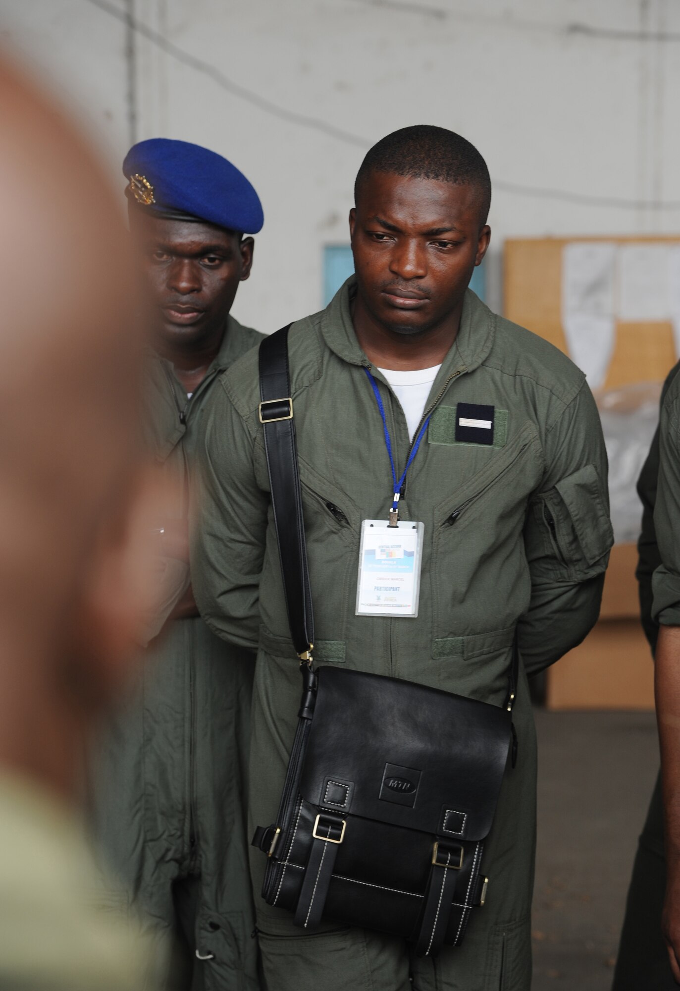 DOUALA, CAMEROON – Cameroon Air Force personnel look on as U.S. Army parachute riggers assigned to the 5th Quartermaster Battalion Detachment, Kaiserslautern, Germany, demonstrate how to build low-cost low-altitude air drop bundles during Central Accord 2013, at the Douala Air Force Base, Douala, Cameroon, February 22, 2013. Central Accord 2013 is a joint exercise in which U.S., Cameroon and neighboring Central African militaries partner to promote regional cooperation while and increasing aerial resupply and medical readiness capacity. (Photo by Master Sgt. MSgt Stan Parker, 621st CRW Public Affairs)