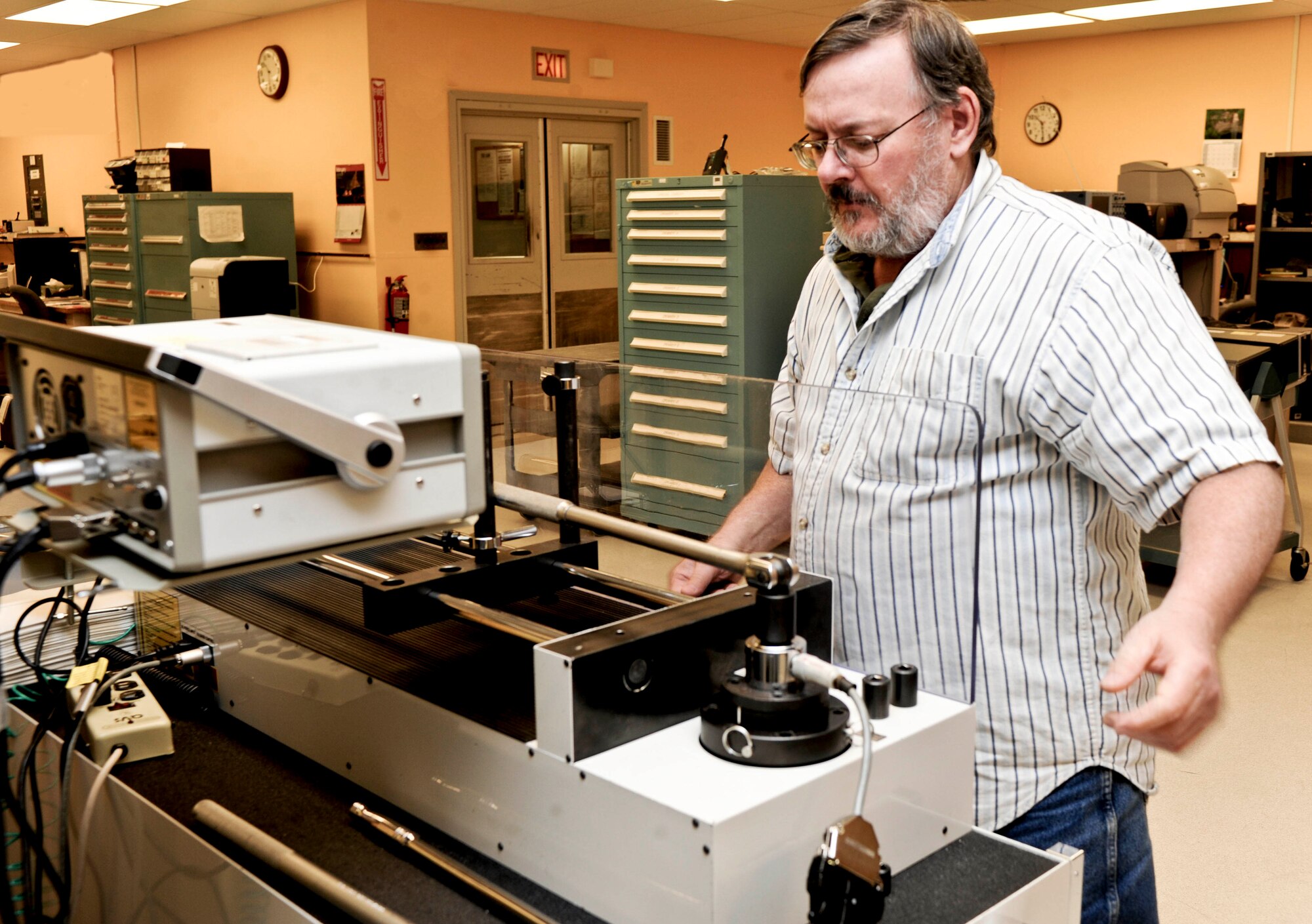 Tom Moeller, 28th Maintenance Squadron precision measurement equipment lab technician, calibrates a torque wrench using a multitest torque, force and angle testing machine at their lab on Ellsworth Air Force Base, S.D., Feb. 20, 2013. Torque wrench calibration ensure fasteners meet exact tension specifications to function safely. (U.S. Air Force photo by Airman 1st Class Anania Tekurio/Released)