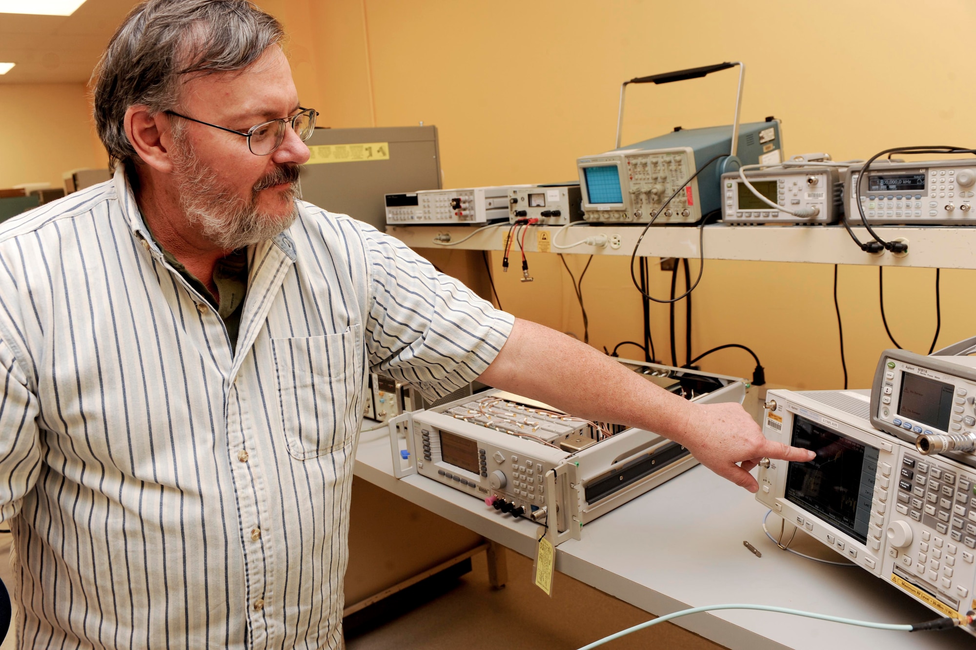 Tom Moeller, 28th Maintenance Squadron precision measurement equipment lab technician, analyzes frequencies of an Anritsu 68347C synthesized signal generator on an Agilent PSA Series Spectrum Analyzer at their building onEllsworth Air Force Base, S.D., Feb. 20, 2013. The spectrum analyzer reads frequencies that help technicians determine if the synthesized signal generator is correctly calibrated. (U.S. Air Force photo by Airman 1st Class Anania Tekurio/Released)