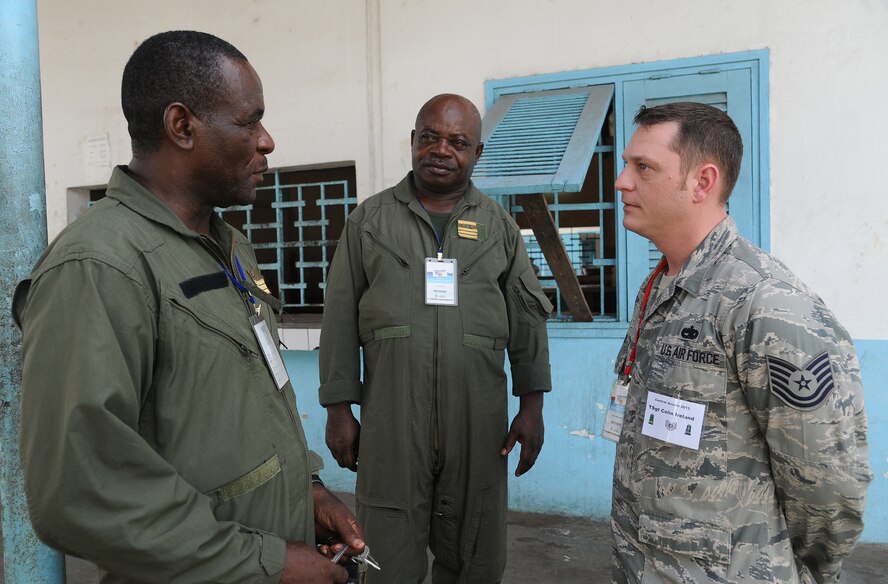 DOUALA, CAMEROON –  U.S. Air Force Technical Sgt. Colin Ireland, an aircraft maintenance air advisor assigned to the 818th Mobility Support Advisory Squadron, Joint Base McGuire-Dix-Lakehurst, N.J., chats with Cameroon Air Force members following the opening ceremony for Central Accord 13, at Douala Air Force Base, Douala, Cameroon, February 20, 2013. Ireland, is participating in Central Accord 2013, a joint exercise in which U.S., Cameroon and neighboring Central African militaries partner to promote regional cooperation while and increasing aerial resupply and medical readiness capacity. (Photo by Master Sgt. MSgt Stan Parker, 621st CRW Public Affairs)