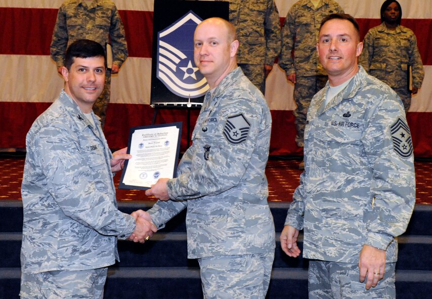Master Sgt. Gregory Stanley, 2nd Security Forces Squadron, receives a certificate of promotion to Master Sgt. from Col. Andrew Gebara, 2nd Bomb Wing commander, during the March Wing Promotion Ceremony on Barksdale Air Force Base, La., March 1. (U.S. Air Force photo/Airman 1st Class Andrew Moua)