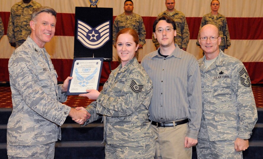 Tech. Sgt. Lynn Means, 608th Air Operations Center, receives a certificate of promotion to Tech. Sgt. from Col. Robert Gass, 8th Air Force vice commander, during the March Wing Promotion Ceremony on Barksdale Air Force Base, La., March 1. (U.S. Air Force photo/Airman 1st Class Andrew Moua)