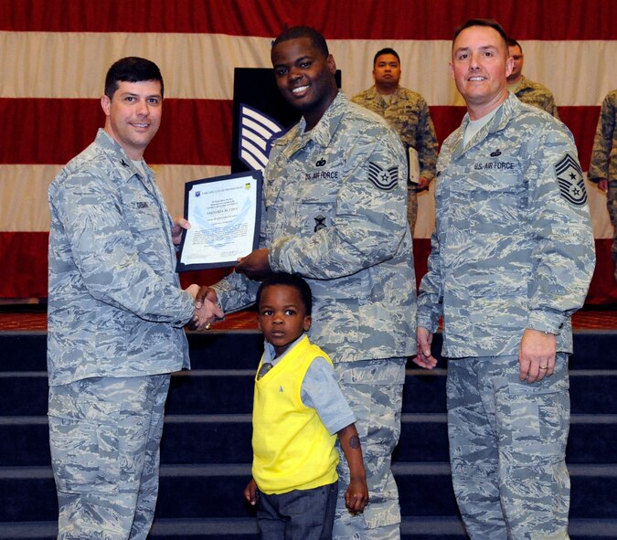 Tech. Sgt. Trendell Cole, 2nd Security Forces Squadron, receives a certificate of promotion to Tech. Sgt. from Col. Andrew Gebara, 2nd Bomb Wing commander, during the March Wing Promotion Ceremony on Barksdale Air Force Base, La., March 1. (U.S. Air Force photo/Airman 1st Class Andrew Moua)