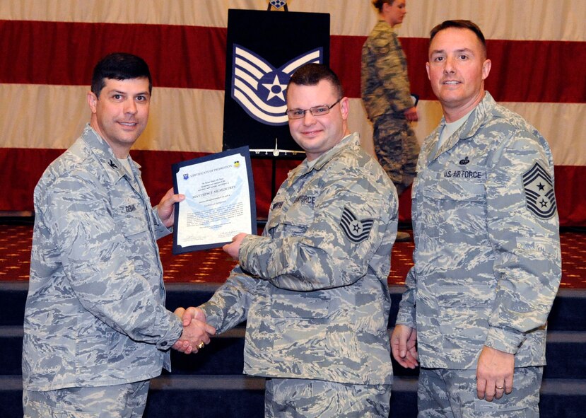Tech. Sgt. Matthew McMurtrey, 2nd Communications Squadron, receives a certificate of promotion to Tech. Sgt. from Col. Andrew Gebara, 2nd Bomb Wing commander, during the March Wing Promotion Ceremony on Barksdale Air Force Base, La., March 1. (U.S. Air Force photo/Airman 1st Class Andrew Moua)