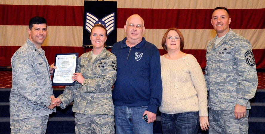 Tech. Sgt. Briana Scott, 2nd Aircraft Maintenance Squadron, receives a certificate of promotion to Tech. Sgt. from Col. Andrew Gebara, 2nd Bomb Wing commander, during the March Wing Promotion Ceremony on Barksdale Air Force Base, La., March 1. (U.S. Air Force photo/Airman 1st Class Andrew Moua)