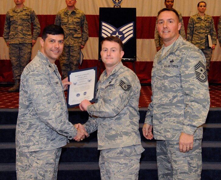 Staff Sgt. Tyler Dove, 26th Operational Weather Squadron, receives a certificate of promotion to Staff Sgt. from Col. Andrew Gebara, 2nd Bomb Wing commander, during the March Wing Promotion Ceremony on Barksdale Air Force Base, La., March 1. (U.S. Air Force photo/Airman 1st Class Andrew Moua)