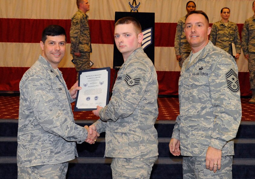 Staff Sgt. Garrett Miller, 2nd Maintenance Squadron, receives a certificate of promotion to Staff Sgt. from Col. Andrew Gebara, 2nd Bomb Wing commander, during the March Wing Promotion Ceremony on Barksdale Air Force Base, La., March 1. (U.S. Air Force photo/Airman 1st Class Andrew Moua)