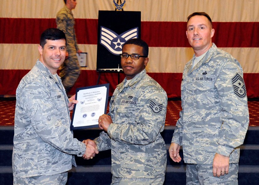 Staff Sgt. Christopher Mahone, 2nd Civil Engineer Squadron, receives a certificate of promotion to Staff Sgt. from Col. Andrew Gebara, 2nd Bomb Wing commander, during the March Wing Promotion Ceremony on Barksdale Air Force Base, La., March 1. (U.S. Air Force photo/Airman 1st Class Andrew Moua)