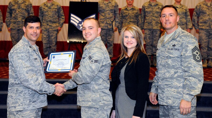 Airman 1st Class Erik Merrill, 2nd Operations Squadron, receives a certificate of promotion to Senior Airman from Col. Andrew Gebara, 2nd Bomb Wing commander, during the March Wing Promotion Ceremony on Barksdale Air Force Base, La., March 1. (U.S. Air Force photo/Airman 1st Class Andrew Moua)