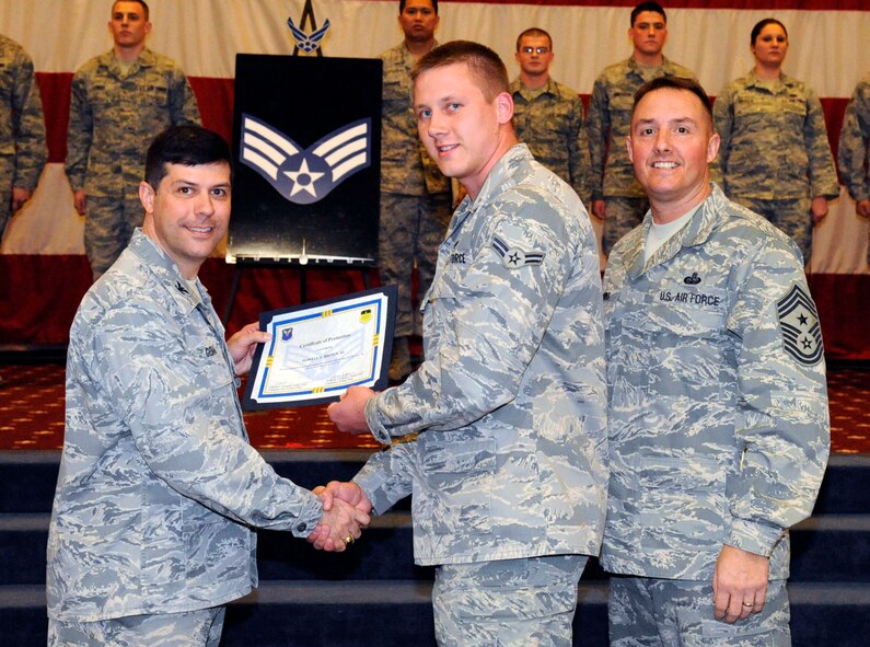 Airman 1st Class Powell Brown, 2nd Operations Squadron, receives a certificate of promotion to Senior Airman from Col. Andrew Gebara, 2nd Bomb Wing commander, during the March Wing Promotion Ceremony on Barksdale Air Force Base, La., March 1. (U.S. Air Force photo/Airman 1st Class Andrew Moua)