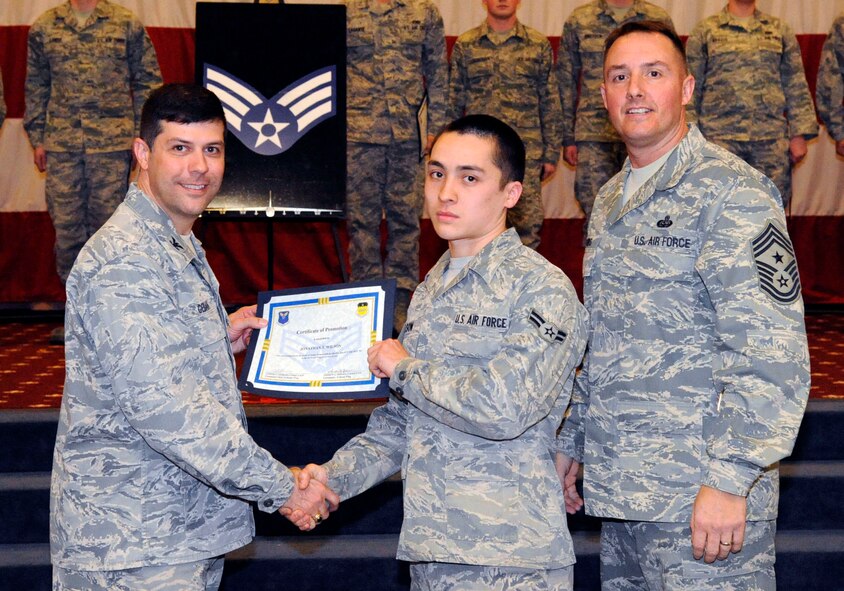Airman 1st Class Jonathan Wilson, 2nd Munitions Squadron, receives a certificate of promotion to Senior Airman from Col. Andrew Gebara, 2nd Bomb Wing commander, during the March Wing Promotion Ceremony on Barksdale Air Force Base, La., March 1. (U.S. Air Force photo/Airman 1st Class Andrew Moua)