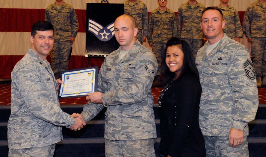 Airman 1st Class Craig Stucker, 2nd Maintenance Squadron, receives a certificate of promotion to Senior Airman from Col. Andrew Gebara, 2nd Bomb Wing commander, during the March Wing Promotion Ceremony on Barksdale Air Force Base, La., March 1. (U.S. Air Force photo/Airman 1st Class Andrew Moua)