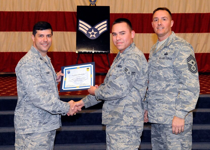 Airman 1st Class Josue Morataya-Garcia, 2nd Aircraft Maintenance Squadron, receives a certificate of promotion to Senior Airman from Col. Andrew Gebara, 2nd Bomb Wing commander, during the March Wing Promotion Ceremony on Barksdale Air Force Base, La., March 1. (U.S. Air Force photo/Airman 1st Class Andrew Moua)