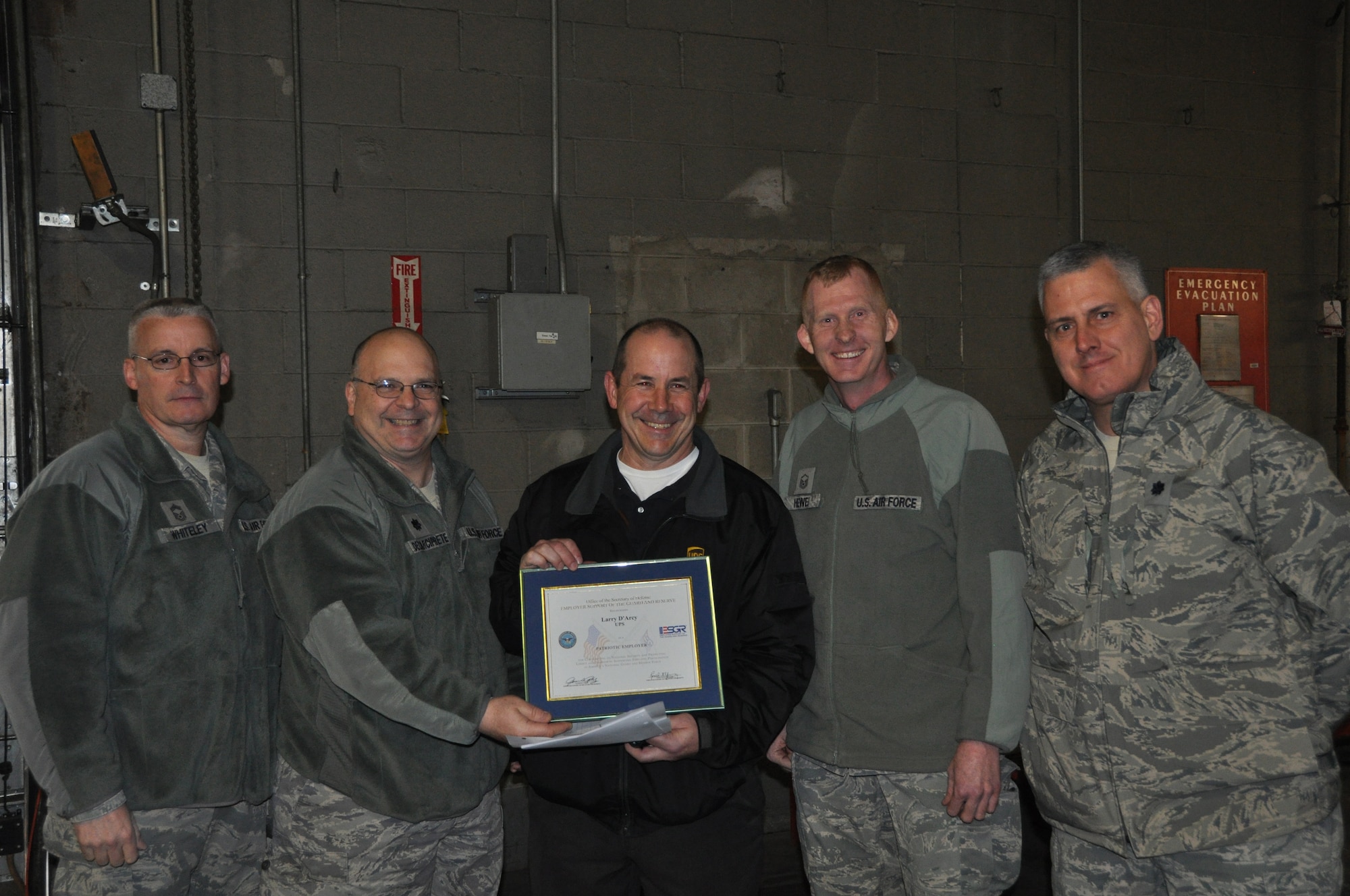 JOINT BASE MCGUIRE-DIX-LAKEHURST, N.J. - Airmen from the 514th Air Mobility Wing recently recognized Larry D'arcy, manager of the Woodbury UPS Center with a Patriot Award for support shown to his Reserve employee, Master Sgt. John Hewel. Pictured are: Chief Master Sgt. James Whiteley, 514th AMW acting command chief; Lt. Col. James Dellarciprete, 514th Mission Support Group, deputy commander; D'arcy; Master Sgt. Hewel and Lt. Col. Relkin Rustin, 514th AMW Employer Support of the Guard and Reserve representative. 