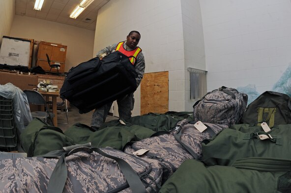 U.S. Air Force Senior Airman Vernon Porter, 4th Aircraft Maintenance Squadron supply journeyman, loads mobility bags onto a cargo pallet during Operational Readiness Inspection CORONET WHITE on Seymour Johnson Air Force Base, N.C., Mar. 5, 2013. The inspection tests Airmen in pre-deployment processes, emergency situations and the ability to survive and operate in a deployed environment. (U.S. Air Force photo/Airman 1st Class John Nieves Camacho/Released)
