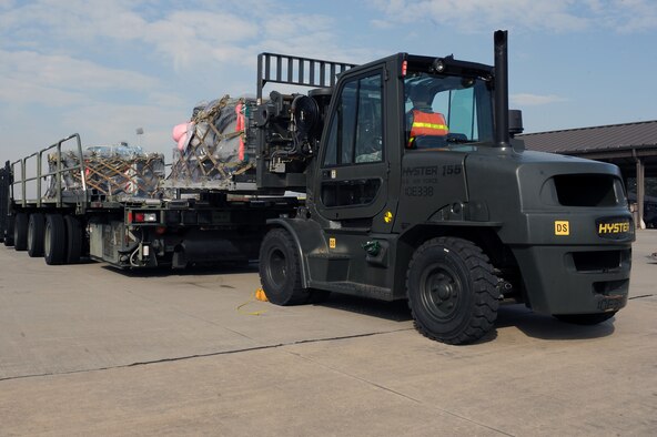 Cargo is loaded onto a trailer bed by 4th Logistics Readiness Squadron Airmen during Operational Readiness Inspection CORONET WHITE on Seymour Johnson Air Force Base, N.C., Mar. 5, 2013. The inspection tests Airmen in pre-deployment processes, emergency situations and the ability to survive and operate in a deployed environment. (U.S. Air Force photo/Airman 1st Class John Nieves Camacho/Released)