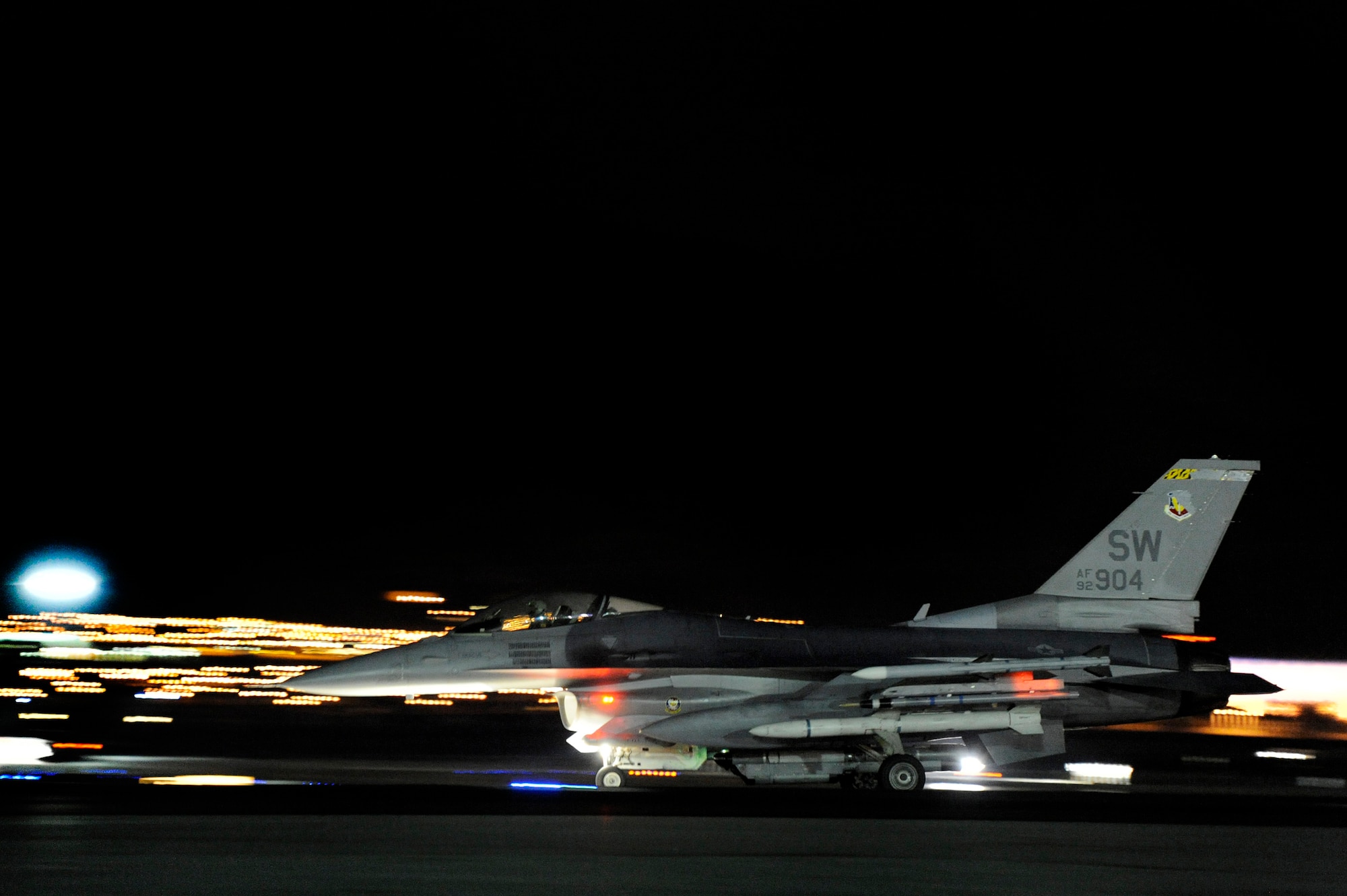 A U.S. Air Force F-16 Fighting Falcon assigned to the 79th Fighter Squadron ‘Tigers’ streaks down the Nellis runway as it takes off for a night mission during Red Flag 13-3, Feb. 27, 2013, Nellis Air Force Base, Nev. Members assigned to the 79th FS have flown around-the-clock to gain as much combat training as possible during the three-week long exercise. (U.S. Air Force photo by Staff Sgt. Kenny Holston/Released)