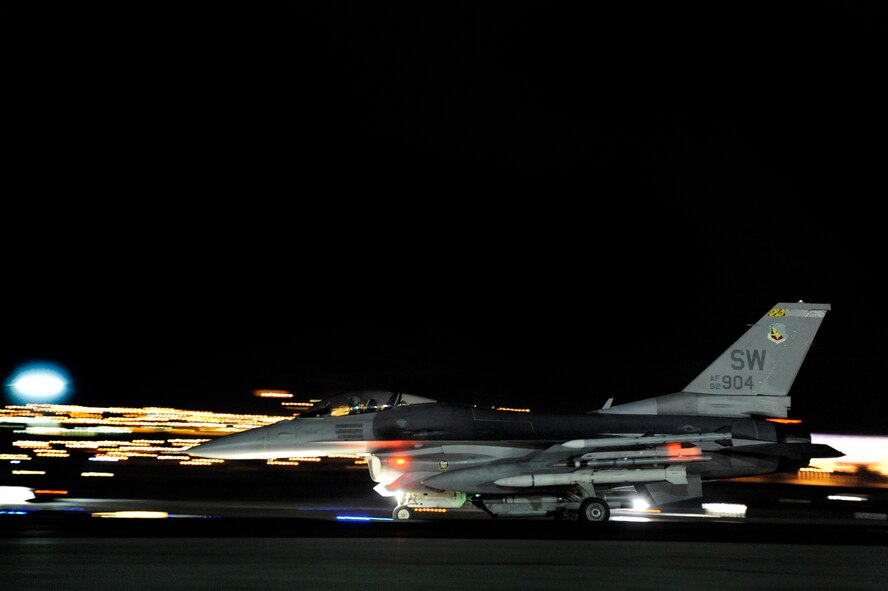 A U.S. Air Force F-16 Fighting Falcon assigned to the 79th Fighter Squadron ‘Tigers’ streaks down the Nellis runway as it takes off for a night mission during Red Flag 13-3, Feb. 27, 2013, Nellis Air Force Base, Nev. Members assigned to the 79th FS have flown around-the-clock to gain as much combat training as possible during the three-week long exercise. (U.S. Air Force photo by Staff Sgt. Kenny Holston/Released)