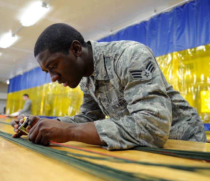 Senior Airman Ernest St. Amand, 2nd Operations Support Squadron Aircrew Flight Equipment Parachute Shop, measures a four-line jettison on Barksdale Air Force Base, La., March 5. If an aircrew member deploys their chute, the four-line jettison is used to steer the individual to safety. (U.S. Air Force photo/Airman 1st Class Benjamin Gonsier) 
