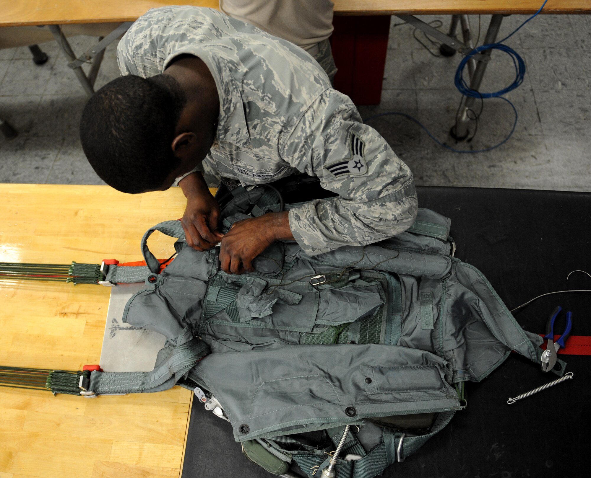 Senior Airman Ernest St. Amand, 2nd Operations Support Squadron Aircrew Flight Equipment Parachute Shop, installs a beacon on a back automatic parachute, BA-18, on Barksdale Air Force Base, La., March 5. Once a parachute is deployed, the beacon will send a message to Air Force rescue services that will show the location of the parachute. (U.S. Air Force photo/Airman 1st Class Benjamin Gonsier)
