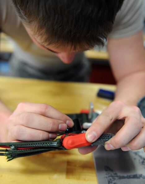 Airman 1st Class Tyler Shepherd, 2nd Operations Support Squadron Aircrew Flight Equipment Parachute Shop, inspects the connector link on a back automatic parachute, BA-18, on Barksdale Air Force Base, La., March 5. The BA-18 is worn by aircrew members during flight and deploys in the event of an ejection. (U.S. Air Force photo/Airman 1st Class Benjamin Gonsier)
