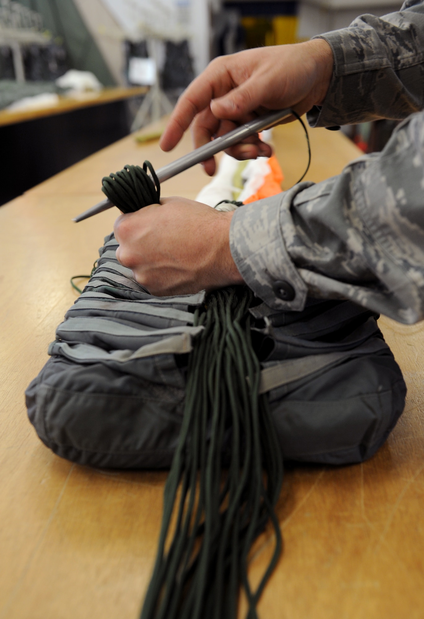 Airman 1st Class Richard James, 2nd Operations Support Squadron Aircrew Flight Equipment Parachute Shop, stows chute lines into a quarter deployment bag on Barksdale Air Force Base, La., March 5. The quarter deployment bag keeps the lines neat and enables the chute to deploy correctly. (U.S. Air Force photo/Airman 1st Class Benjamin Gonsier)
