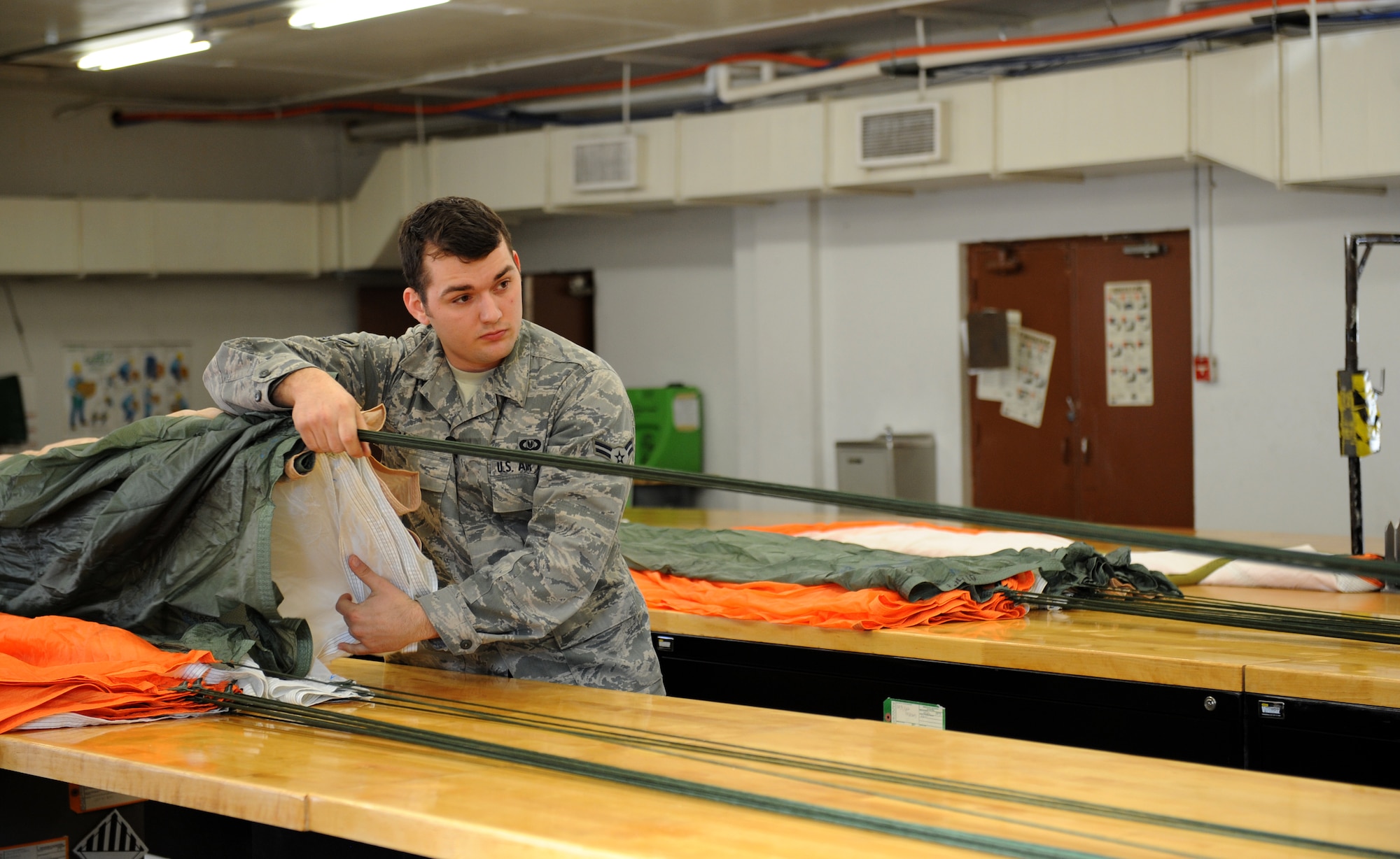 Airman 1st Class Richard James, 2nd Operations Support Squadron Aircrew Flight Equipment Parachute Shop, conducts a line check for a parachute on Barksdale Air Force Base, La., March 5. The line check ensures the chute lines are in the right order. The AFE parachute shop is in charge of packing, inspecting and supplying B-52H Stratofortress aircrew with their parachutes. (U.S. Air Force photo/Airman 1st Class Benjamin Gonsier)
