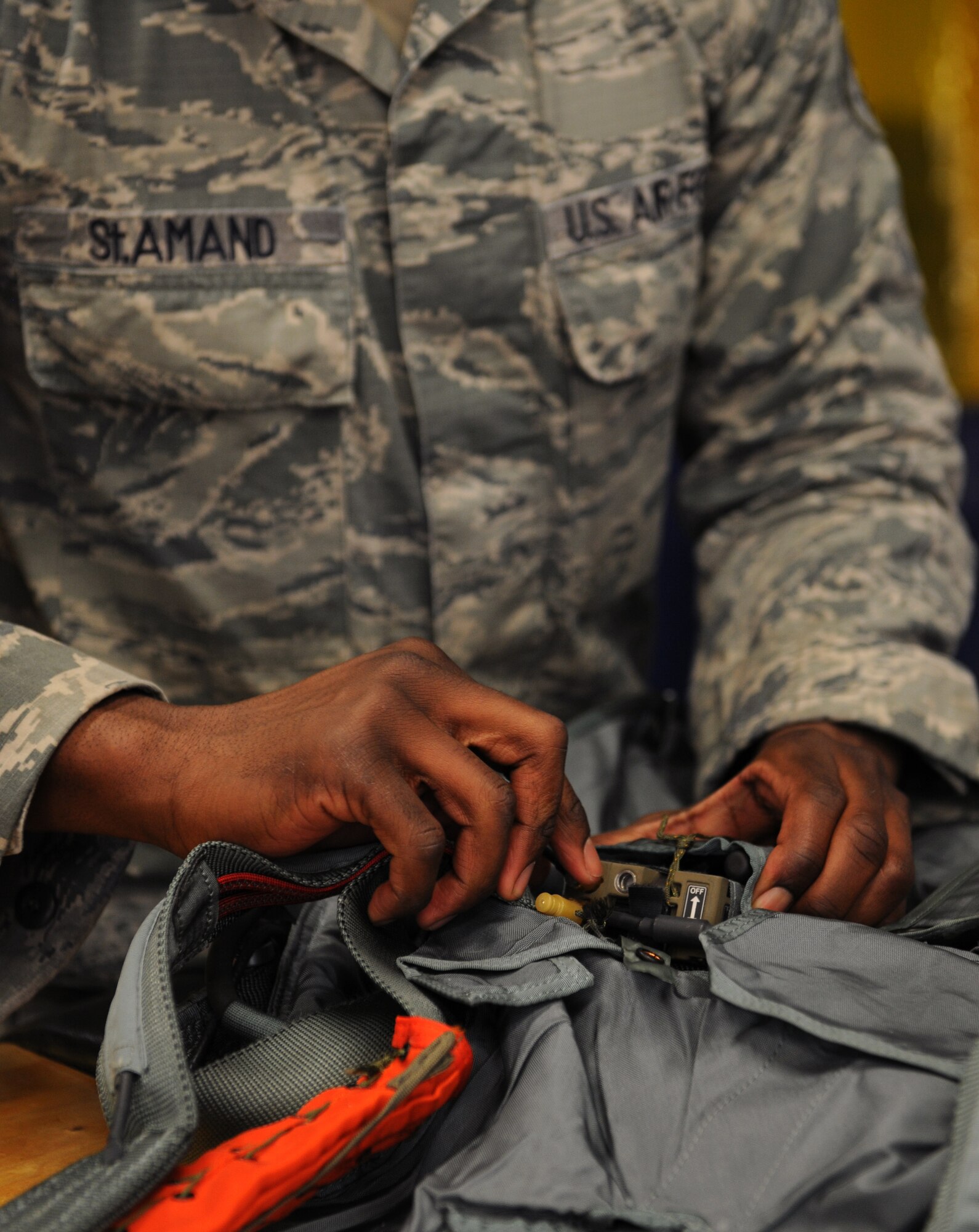 Senior Airman Ernest St. Amand, 2nd Operations Support Squadron Aircrew Flight Equipment Parachute Shop, inspects the beacon on a back automatic parachute, BA-18, on Barksdale Air Force Base, La., March 5. Once a parachute is deployed, the beacon will send a message to Air Force rescue services that will show the location of the parachute. (U.S. Air Force photo/Airman 1st Class Benjamin Gonsier)
